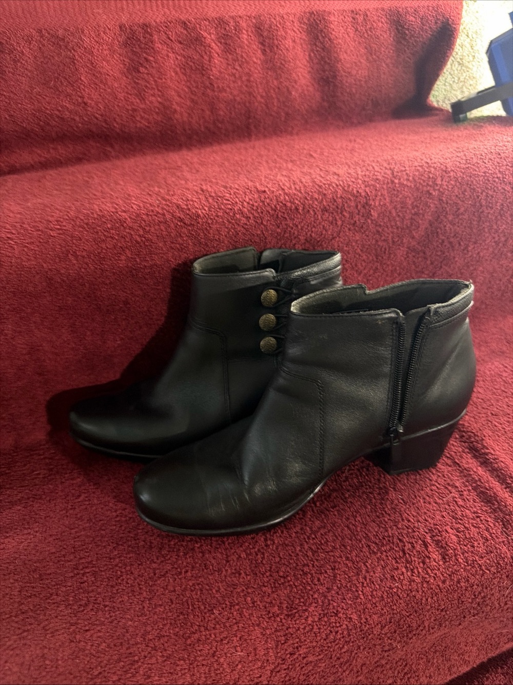 Woman’s Black Leather Ankle Booties with Button Accents by Clark’s